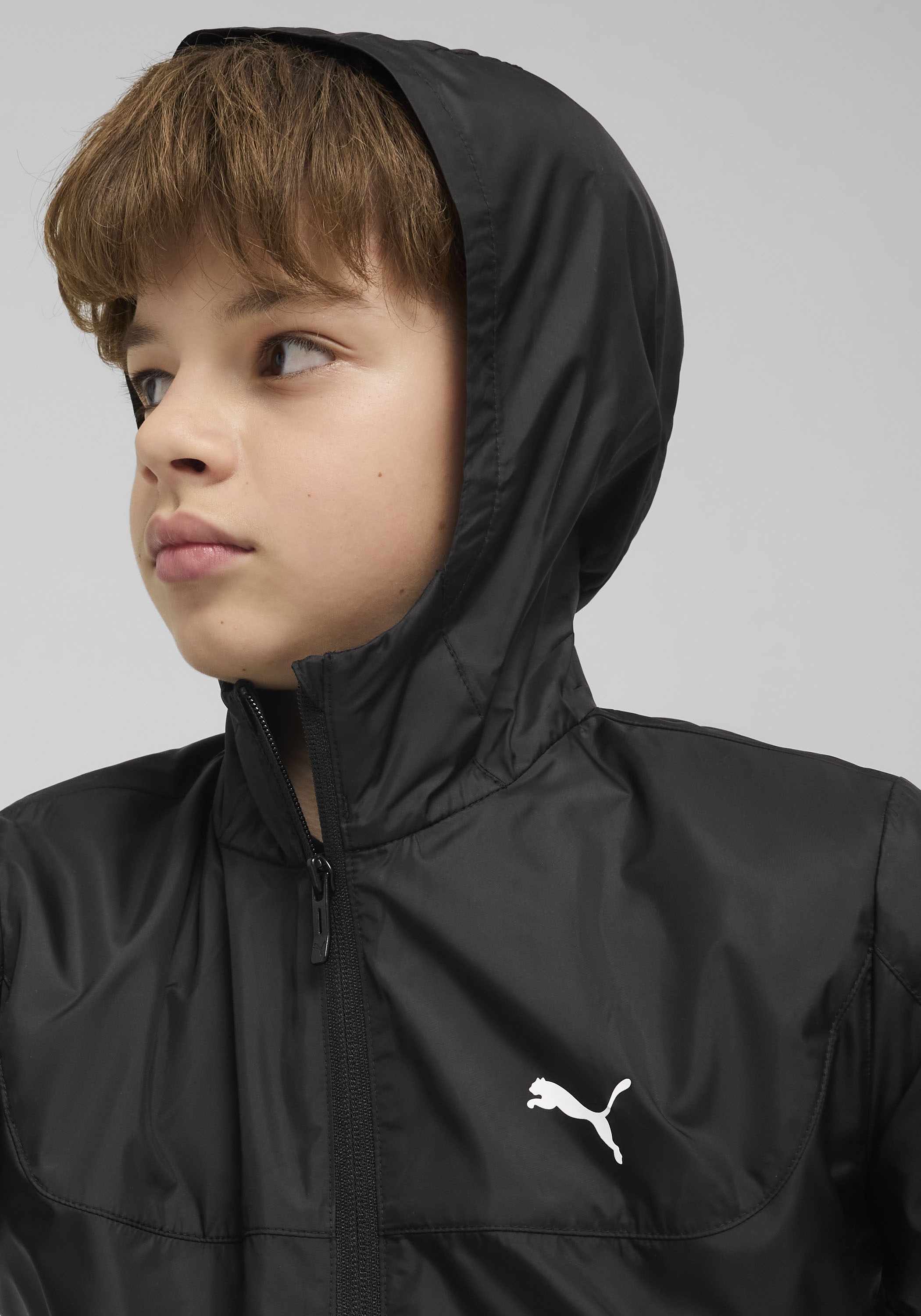 PUMA Windbreaker »ESS REGULAR WINDBREAKER« mit Kapuze für Jugendliche, mit Kapuze, mit Eingrifftasche