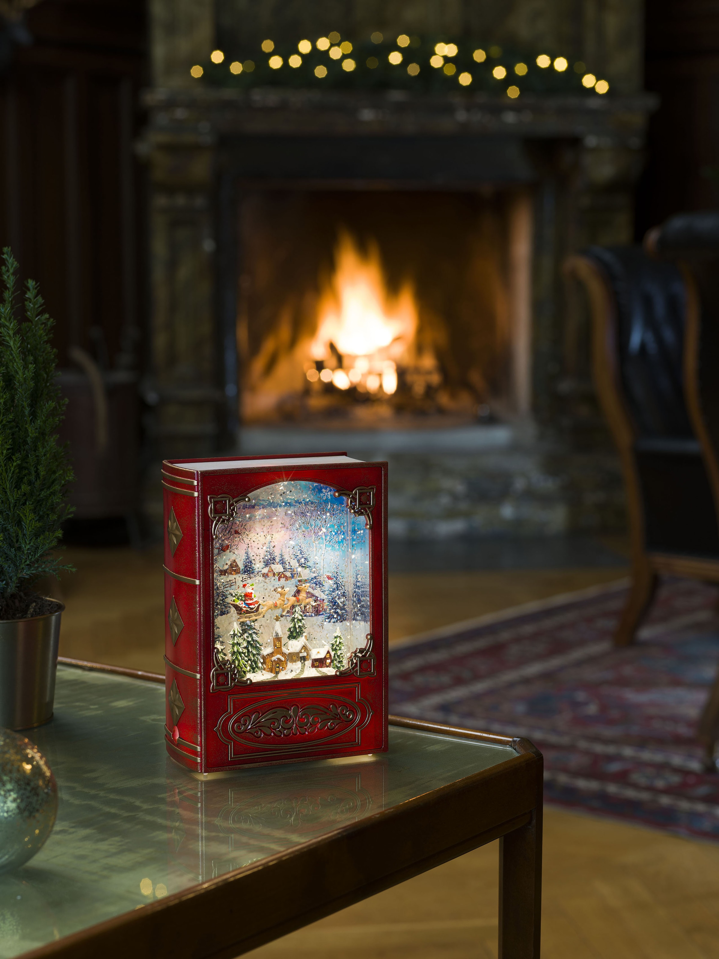 KONSTSMIDE LED Laterne, 1 flammig-flammig, Wasserlaterne, "Weihnachtsmann im Schlitten mit Rentieren über Dorf"